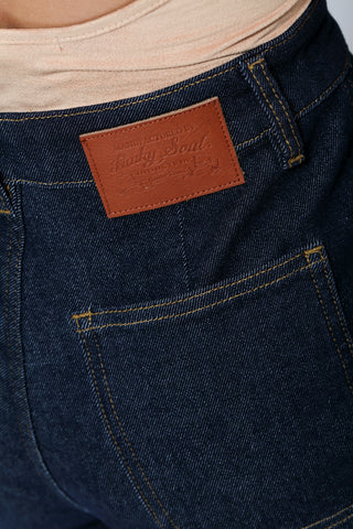 Close-up of Funky Soul High-Rise Barrel Leg Jeans back pocket with signature Funky Soul leather tag.